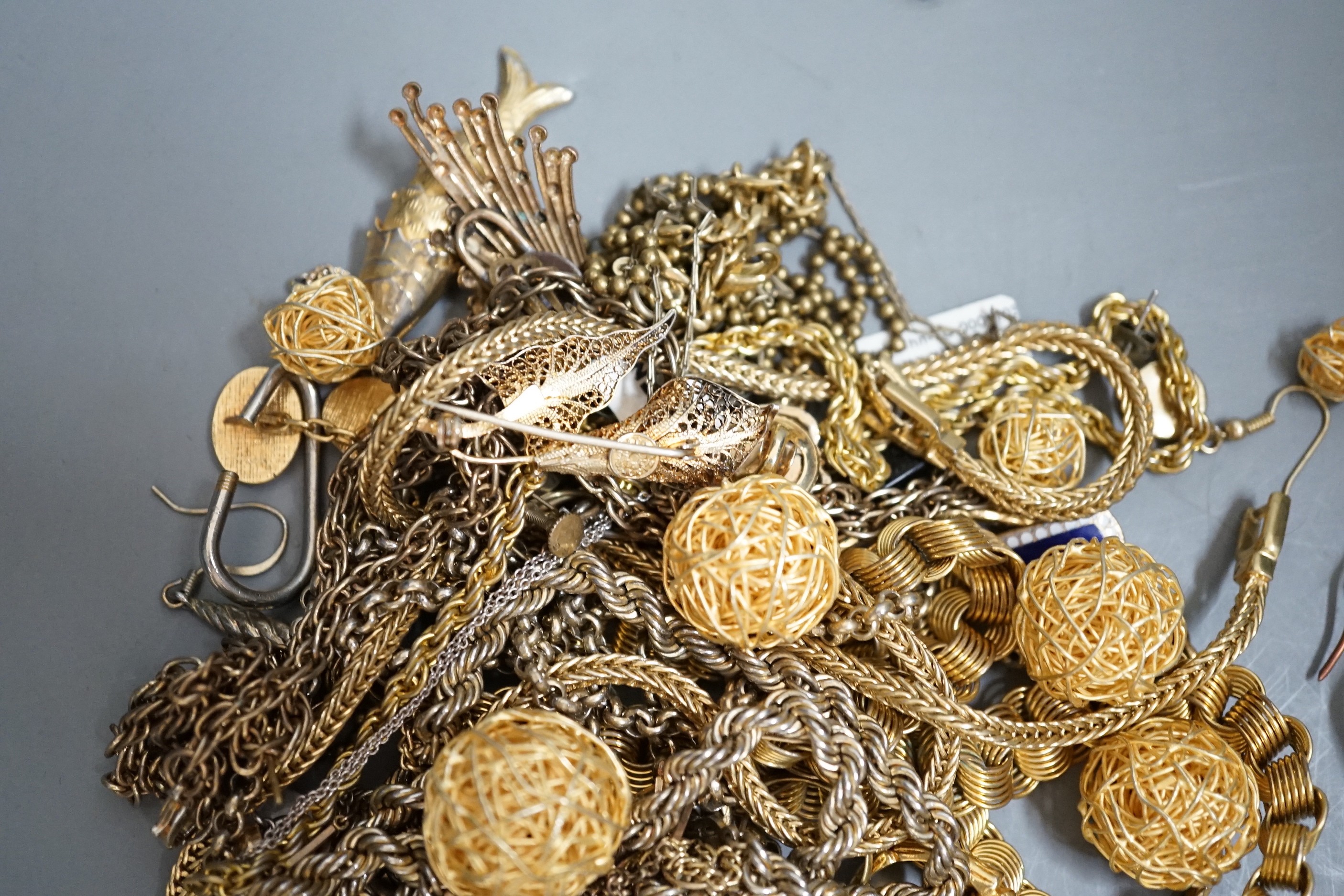 A group of assorted mainly gilt metal costume jewellery.